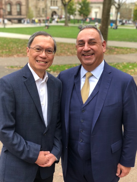 kenneth wong and gil cisneros shaking hands and smiling at camera