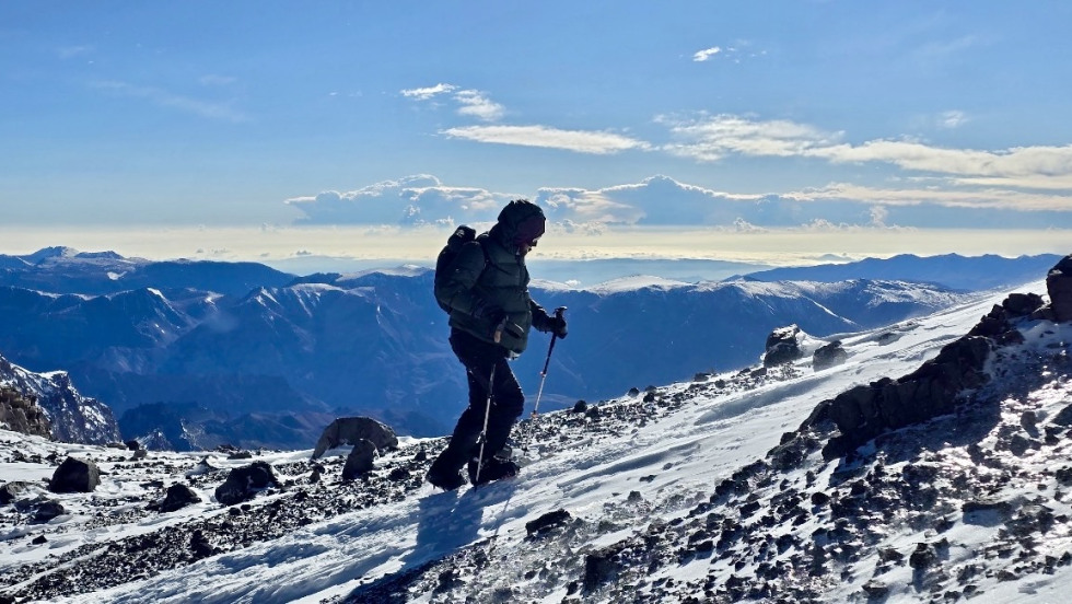 Manning hiking up a mountain 