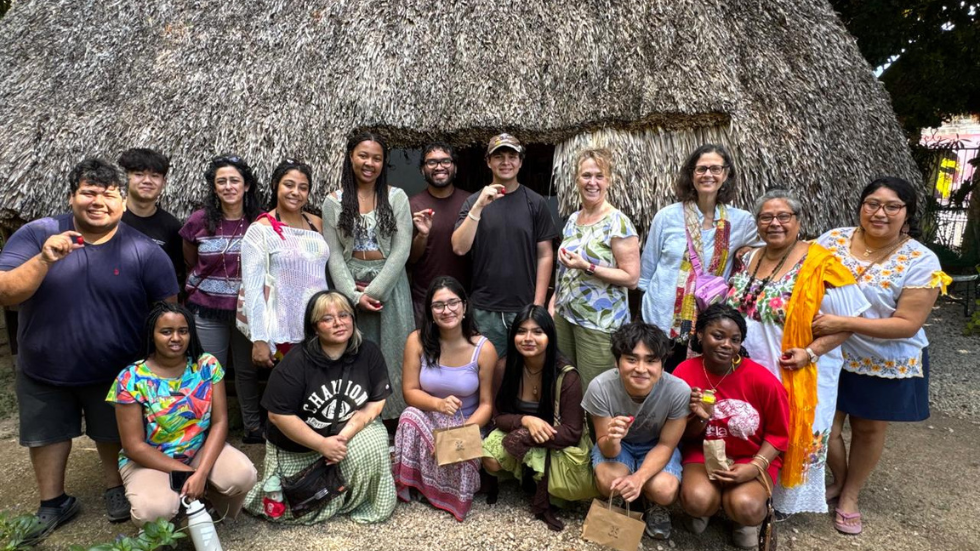 Students and faculty smiling on a field trip 